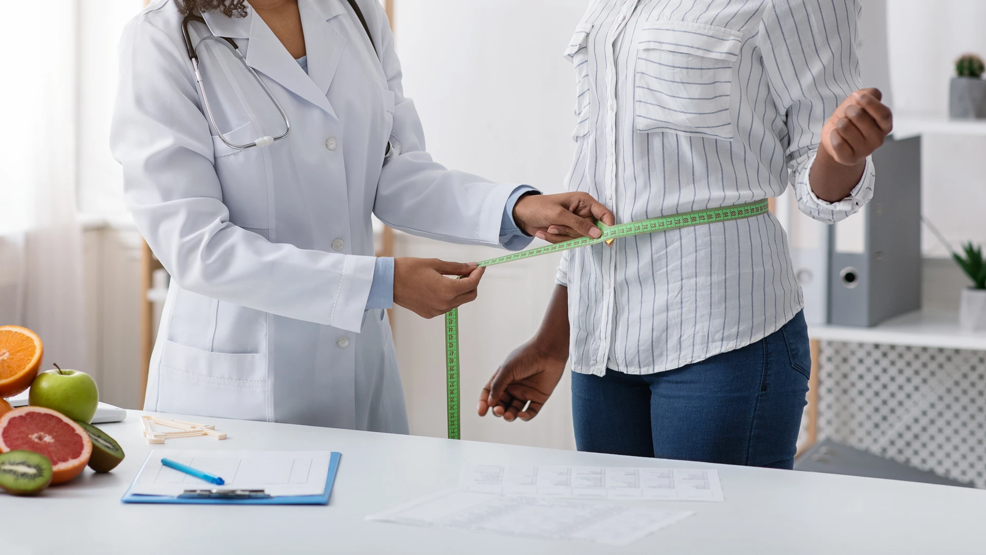 Medical weight loss program with Dr. Carolina Braga showing a doctor measuring a patient’s waist as part of personalized weight management care.